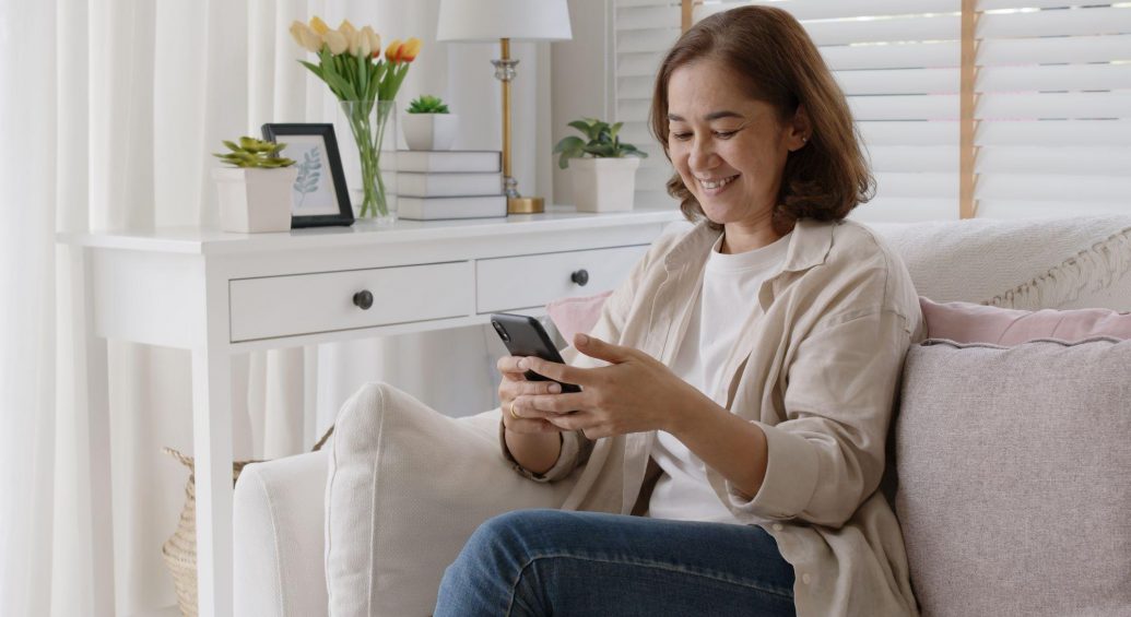 Senior smiling while texting