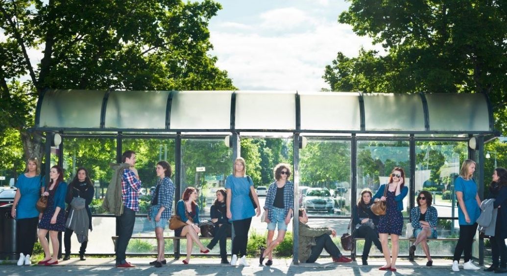 people waiting for transportation at bus stop